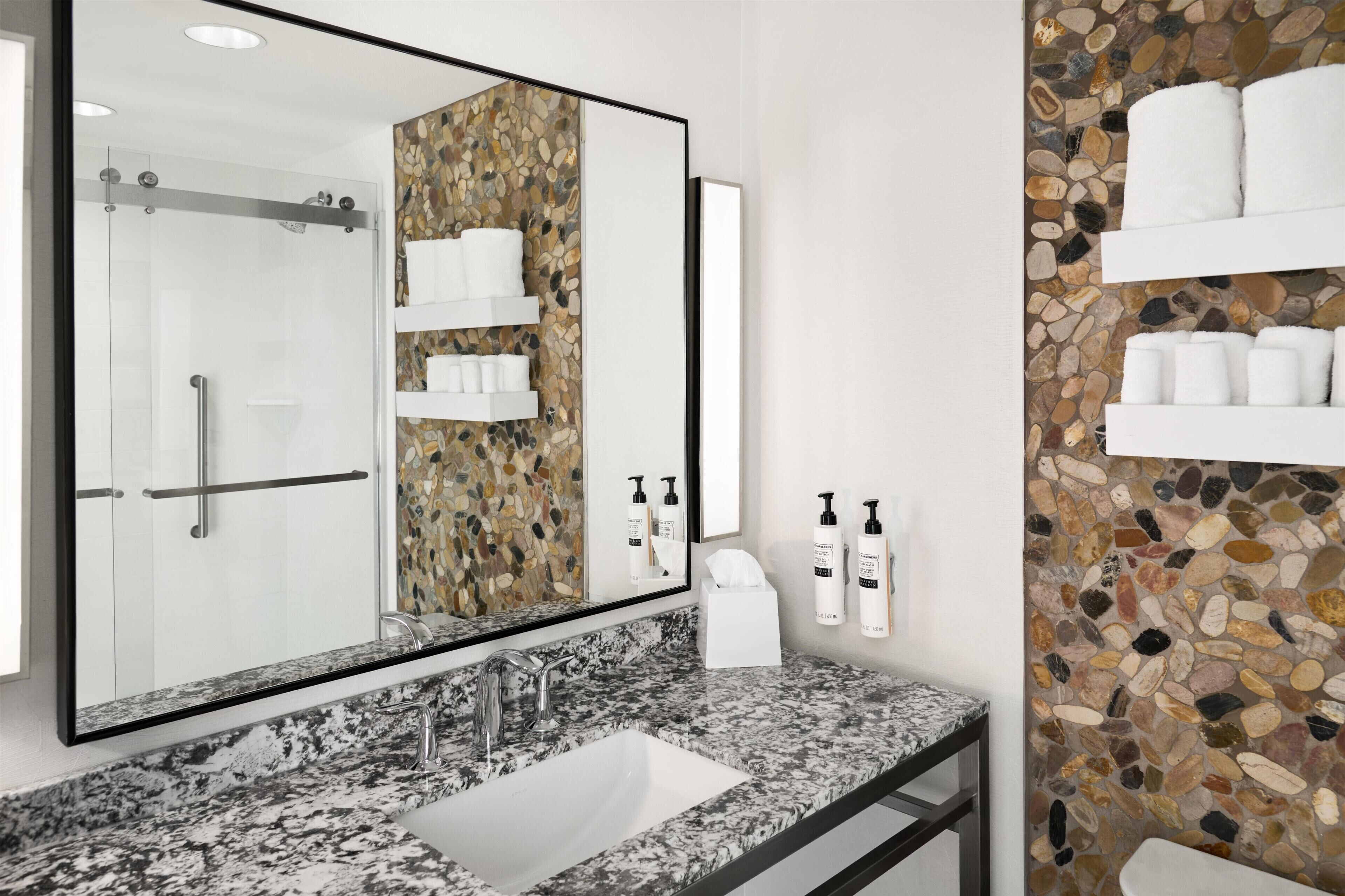 Designer toiletries, hair dryer, towels, toilet paper