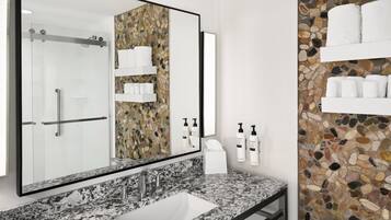 Designer toiletries, hair dryer, towels, toilet paper