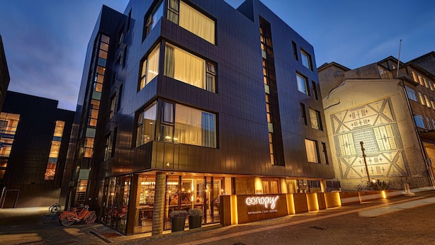 A modern building with a restaurant named "Canopy" at its ground level. - Canopy by Hilton Reykjavik City Centre (Reykjavik)