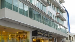 A modern hotel building with a prominent entrance and large windows. - Hotel Libertador (Loja)