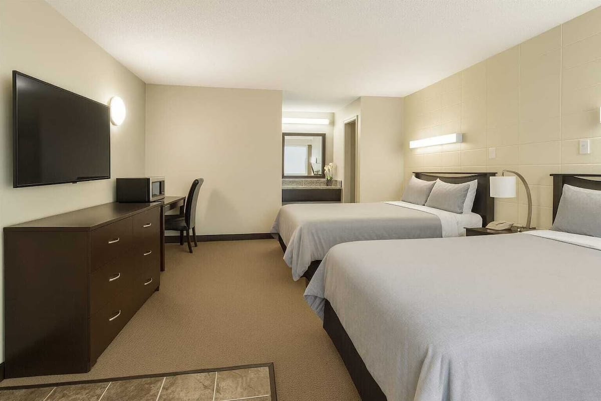 Economy Room, 2 Queen Beds | Blackout drapes, free WiFi