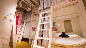 A bunk bed room with a ladder, white walls, and a sign indicating a "quiet phase." - Senba Hostel (Osaka)