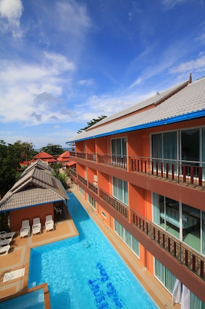 A hotel with a swimming pool, multiple balconies, and a view of the surrounding area. - Lanta Fevrier Resort (Ko Lanta)