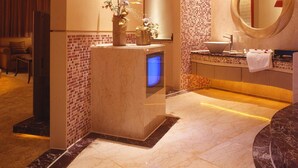 A modern bathroom with a star-shaped decoration, a vanity with a mirror, and a small plant.