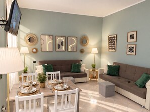 Un salon moderne avec un canapé marron, des chaises blanches, une table à manger dressée pour quatre personnes et des œuvres d’art décoratives accrochées au mur.