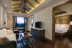 A hotel room with a balcony, a TV, a bed, and a dining area. - Hilton Sanqingshan Resort (Shangrao)