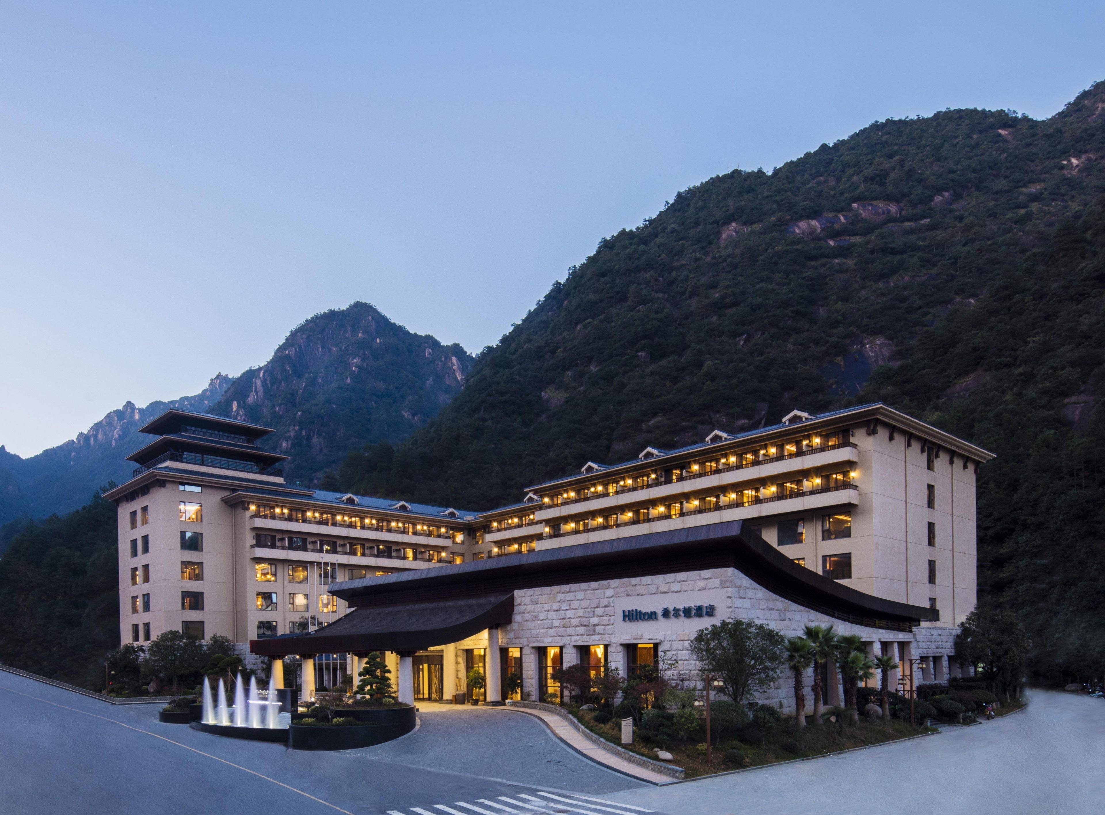 A multi-story hotel with a traditional architectural style, located in a mountainous area.