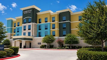 A multi-story hotel with a modern design, featuring a mix of stone and painted exteriors.