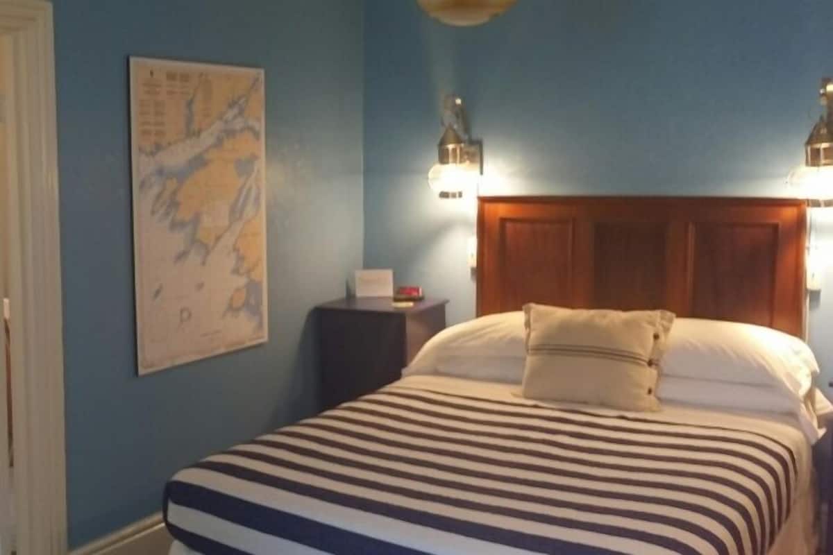 Peterson Room | Individually decorated, individually furnished, desk, iron/ironing board