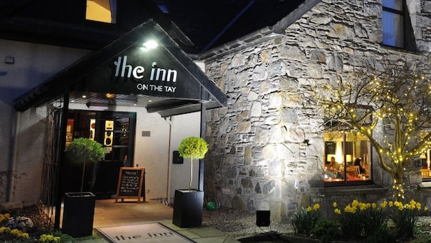 A stone building with a sign reading "The Inn ON THE TAY."