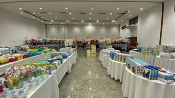 A spacious room with multiple tables displaying various items, likely for sale.