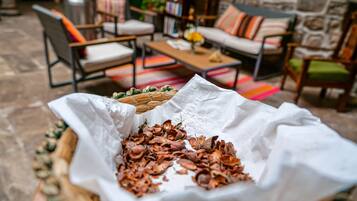 A cozy outdoor seating area with a wicker basket and a paper bag filled with dried leaves.
