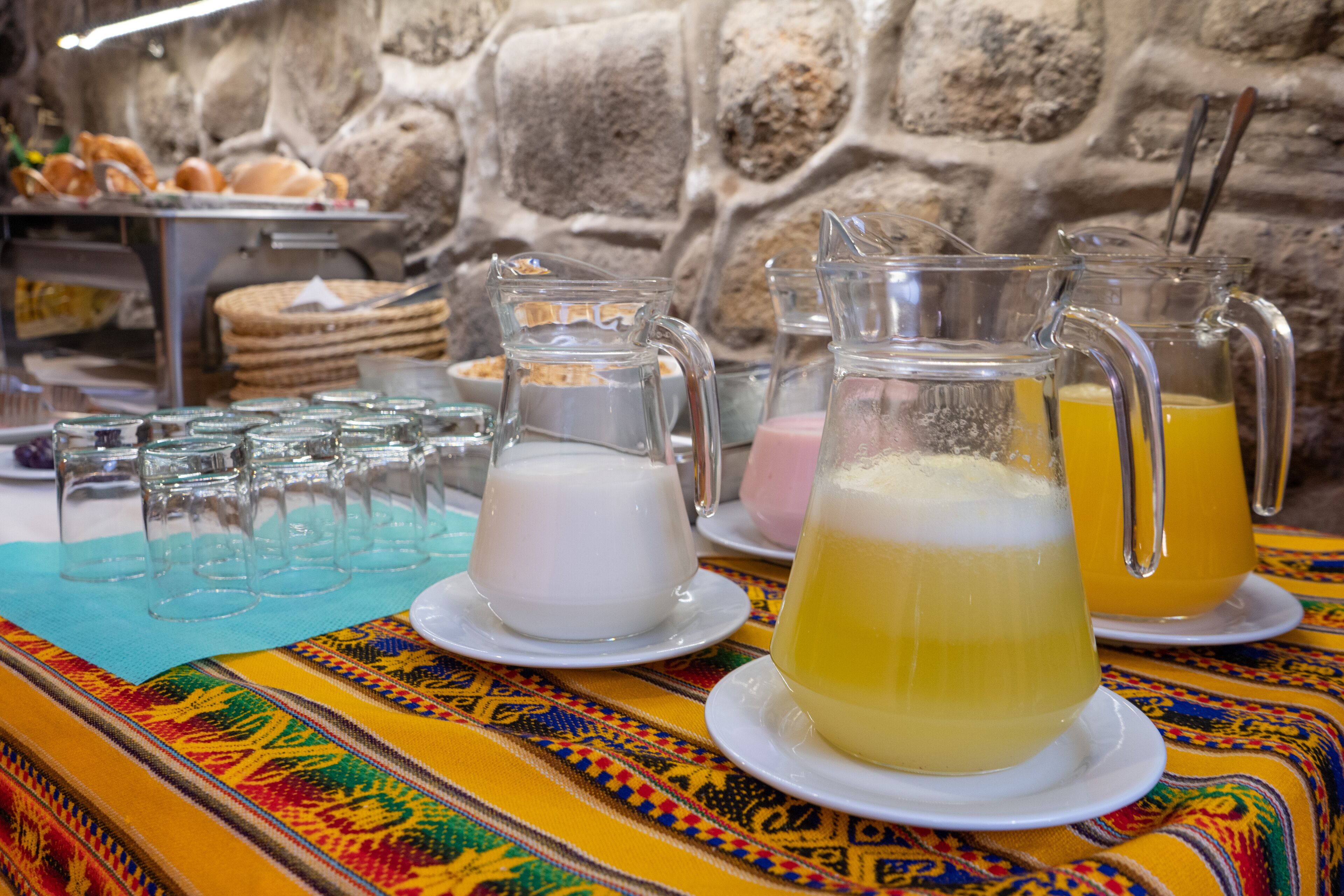 A buffet table with various food items and beverages.