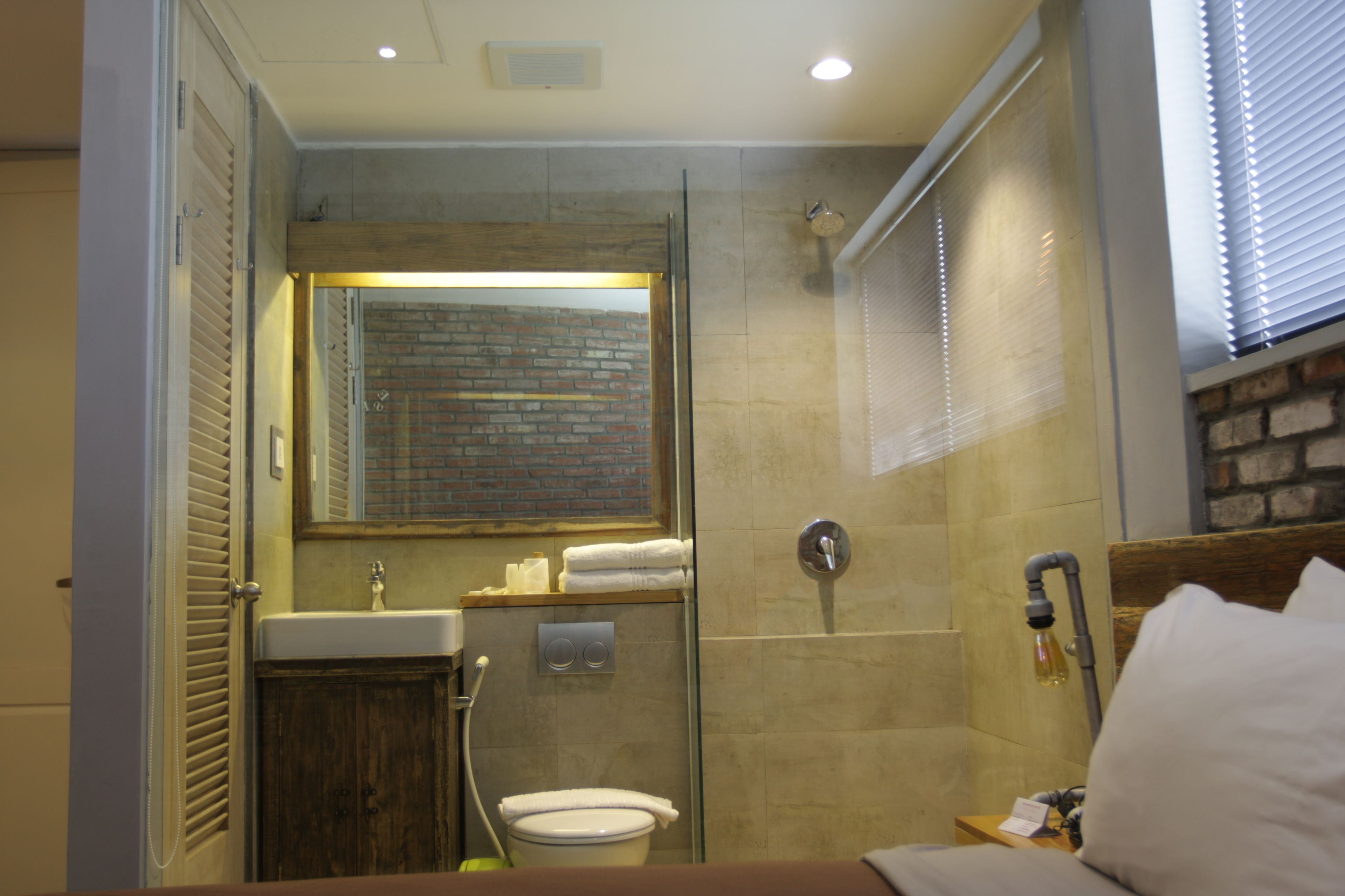 A bathroom with a shower, toilet, and sink.