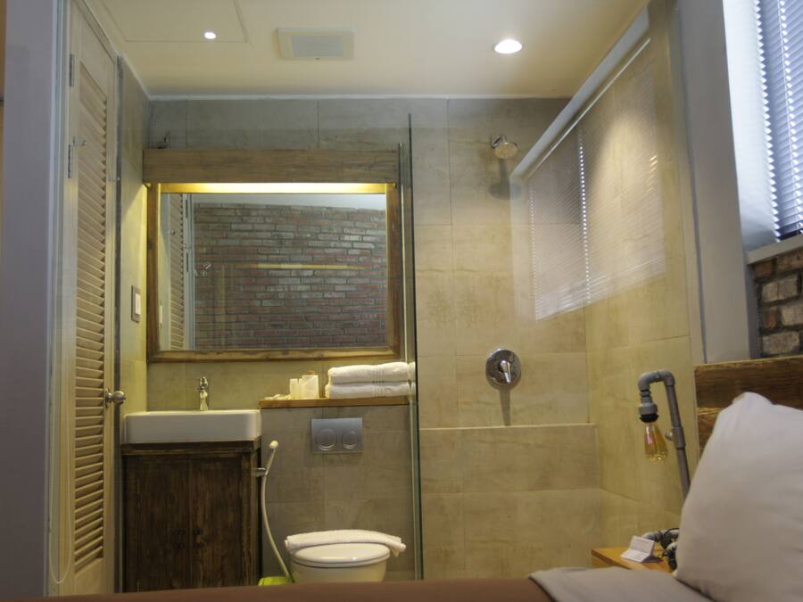 A bathroom with a shower, toilet, and sink.