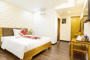 Una habitación de hotel con cama, escritorio y armario.