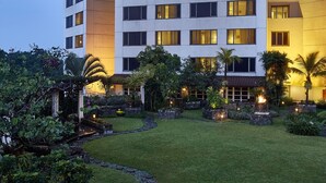 A multi-story hotel with a modern design, featuring a prominent sign at the top. - Aryaduta Bandung (Bandung)