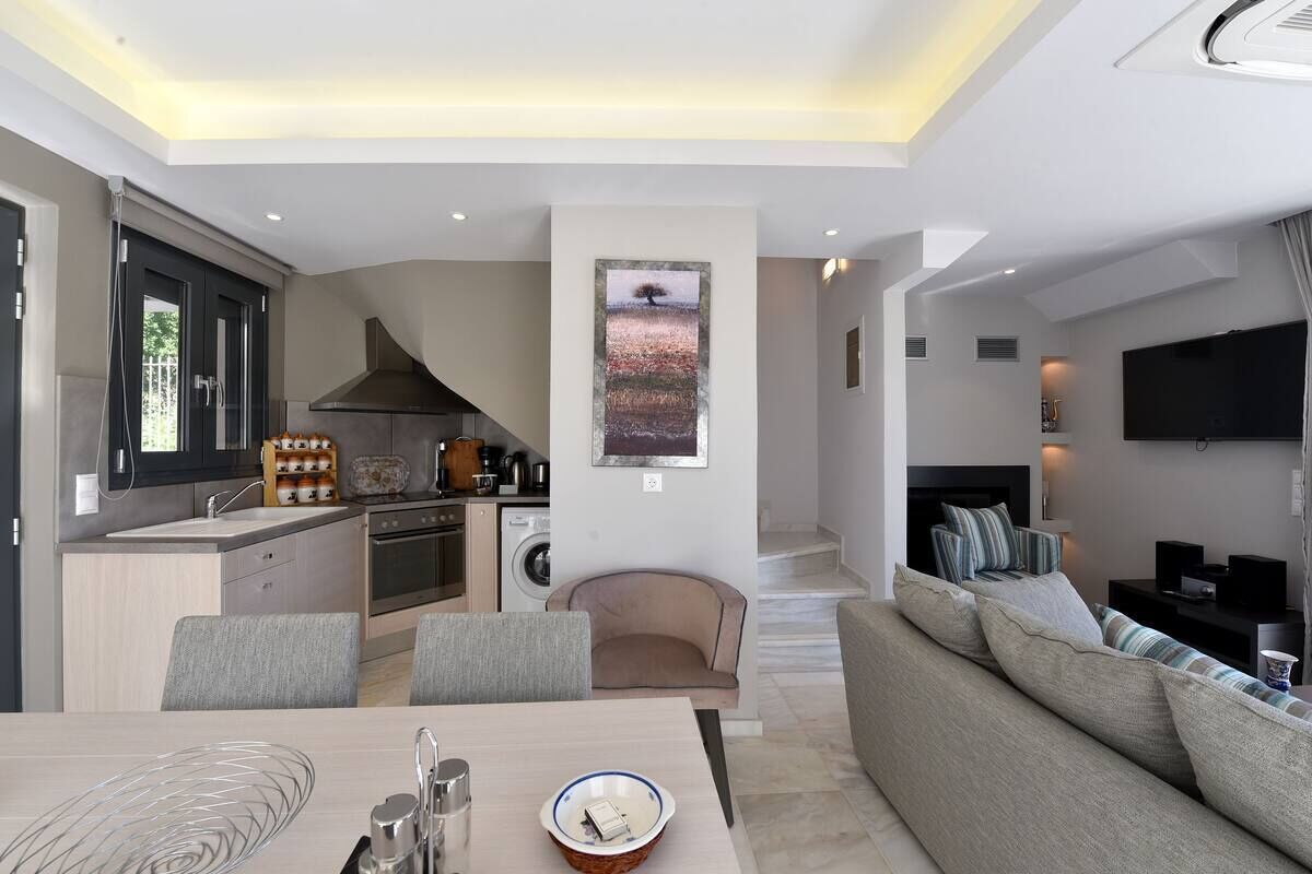 suite one bedroom split level with sharing pool and mountain view | living area | led tv