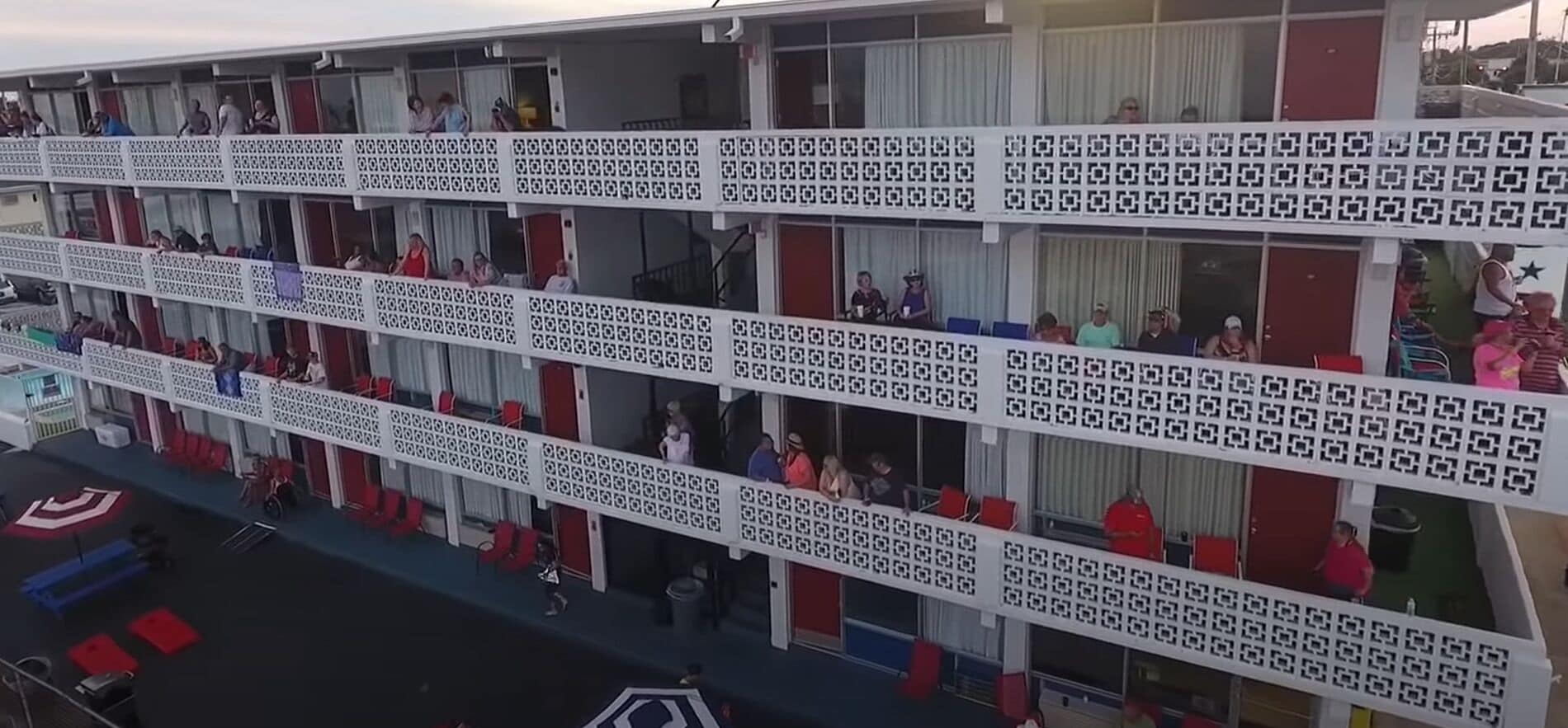A multi-story hotel with balconies, each with a patterned railing.