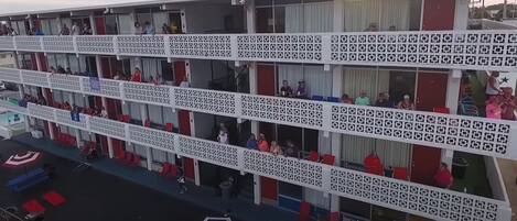 A multi-story hotel with balconies, each with a patterned railing.