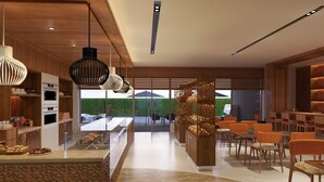 A modern kitchen with a central island, wooden cabinetry, and pendant lighting. - Courtyard by Marriott Raipur (Raipur)