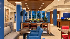 A modern hotel lobby with a bar area, seating arrangements, and a reception desk. - Holiday Inn Express & Suites Boise Airport by IHG (Boise)
