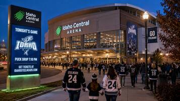The Idaho Central Arena with a large entrance and a crowd of people.