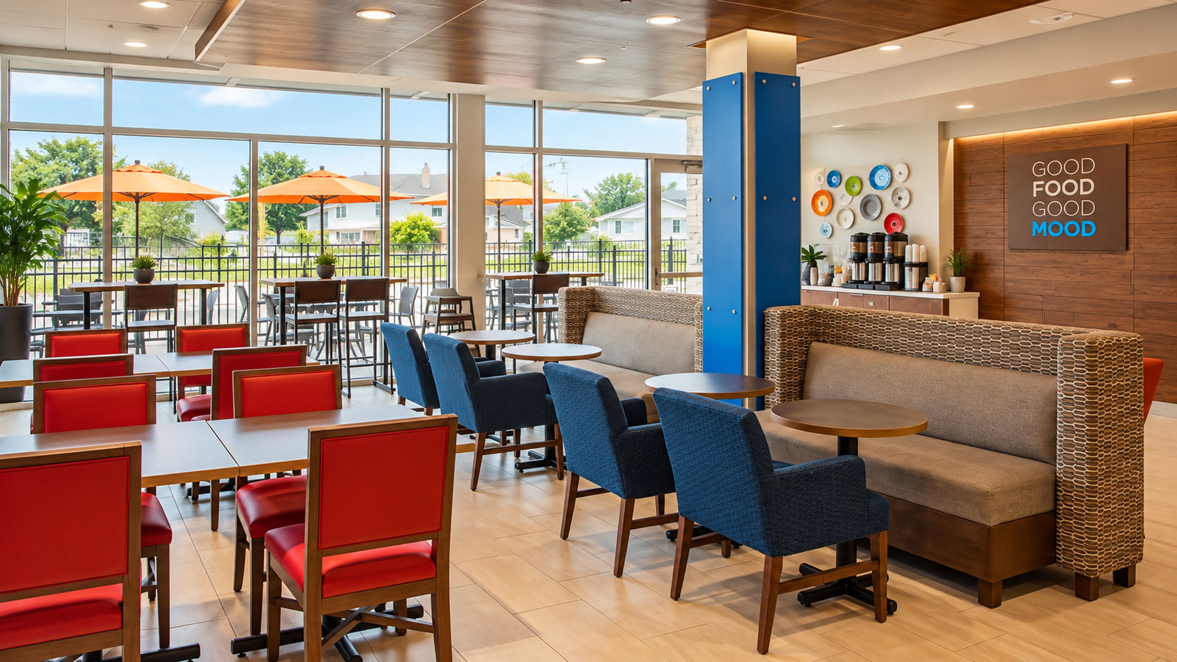 A restaurant with indoor seating, large windows, and a view of the outside.
