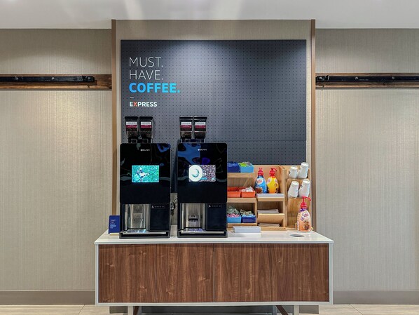 Two coffee machines on a counter with a sign above them that reads "MUST HAVE COFFEE." - Holiday Inn Express & Suites Boise Airport by IHG (Boise)