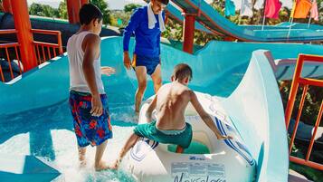 A water park with a water slide and inflatable rafts.