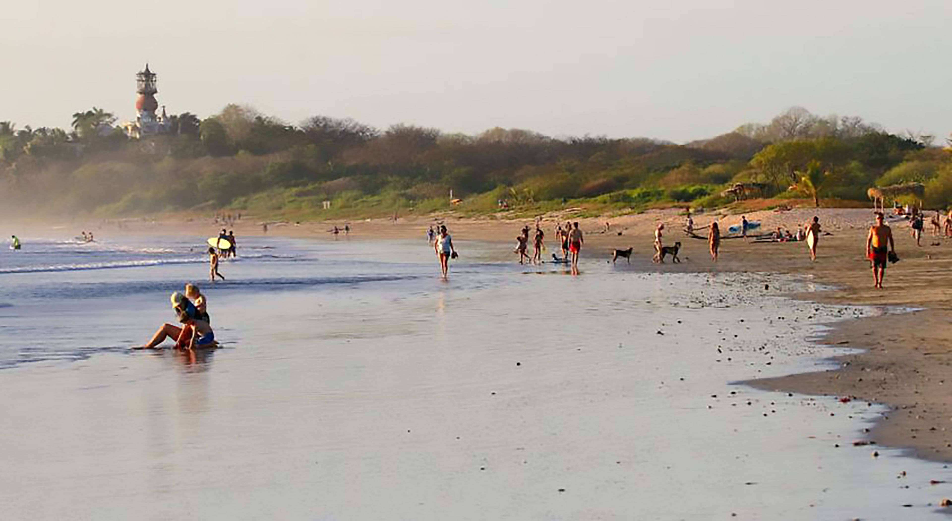 on the beach, surfing