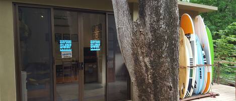 A building with glass doors and a sign reading "Safari Surf".