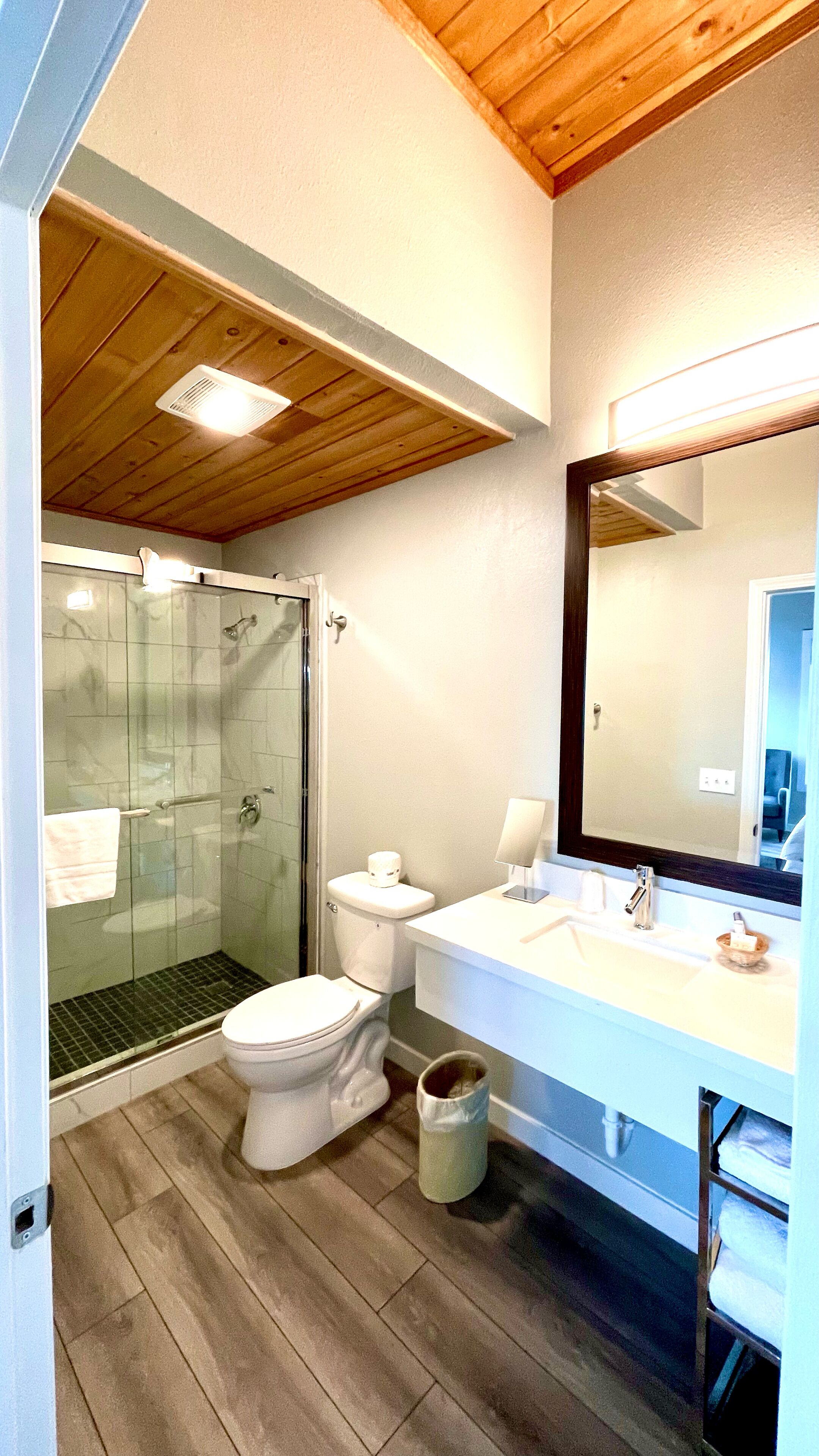 A bathroom with a shower, toilet, and sink.