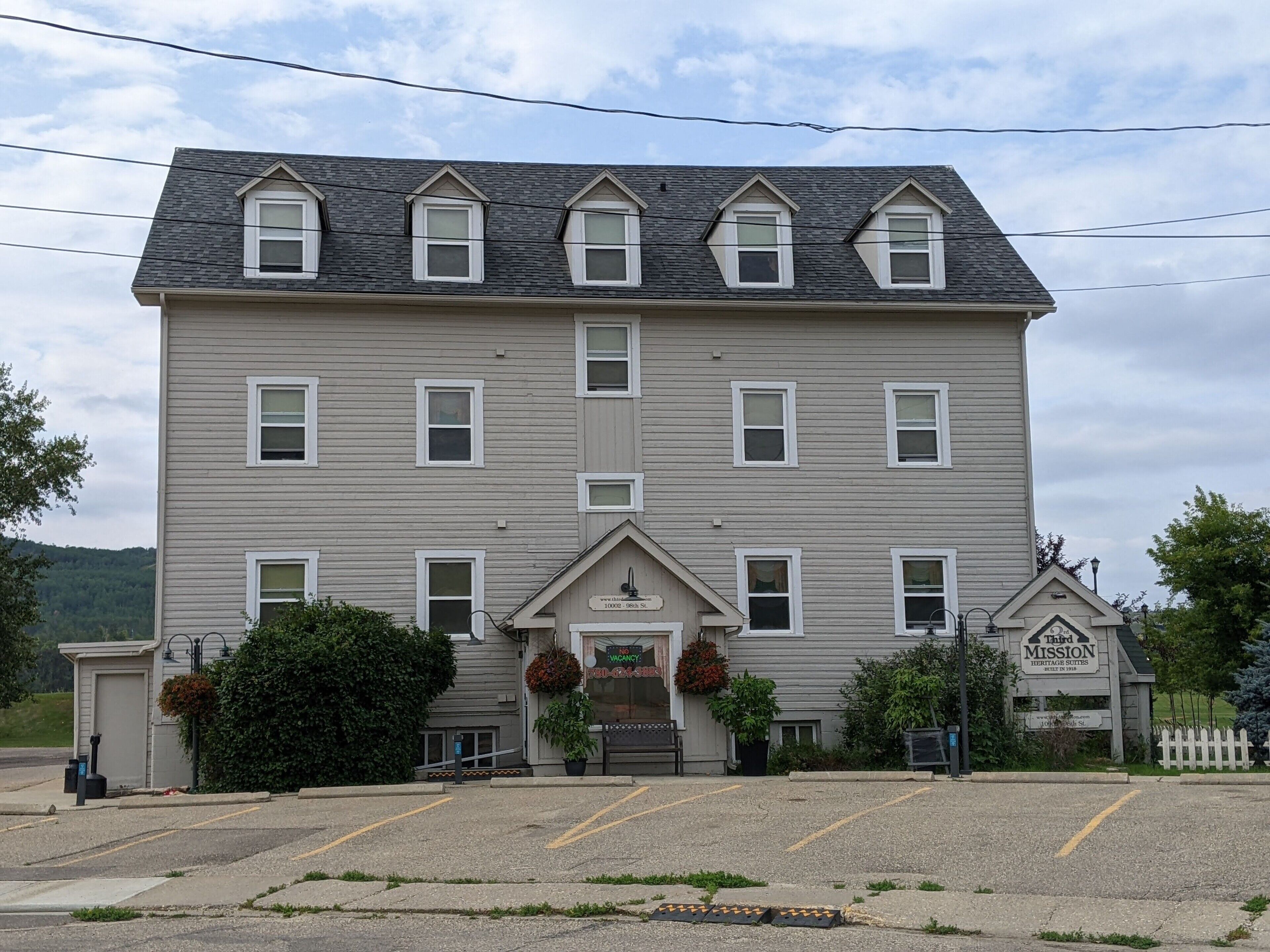 A multi-story hotel with a symmetrical facade, multiple windows, and a central entrance.