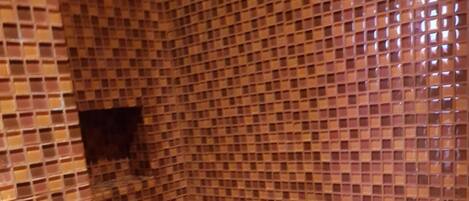 A tiled shower enclosure with a checkered pattern.