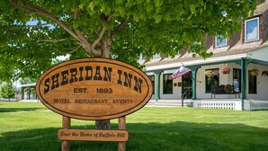 A wooden sign for Sheridan Inn, established in 1893, offering hotel, restaurant, and events services. - Sheridan Inn, B/W Signature Collection (Sheridan)