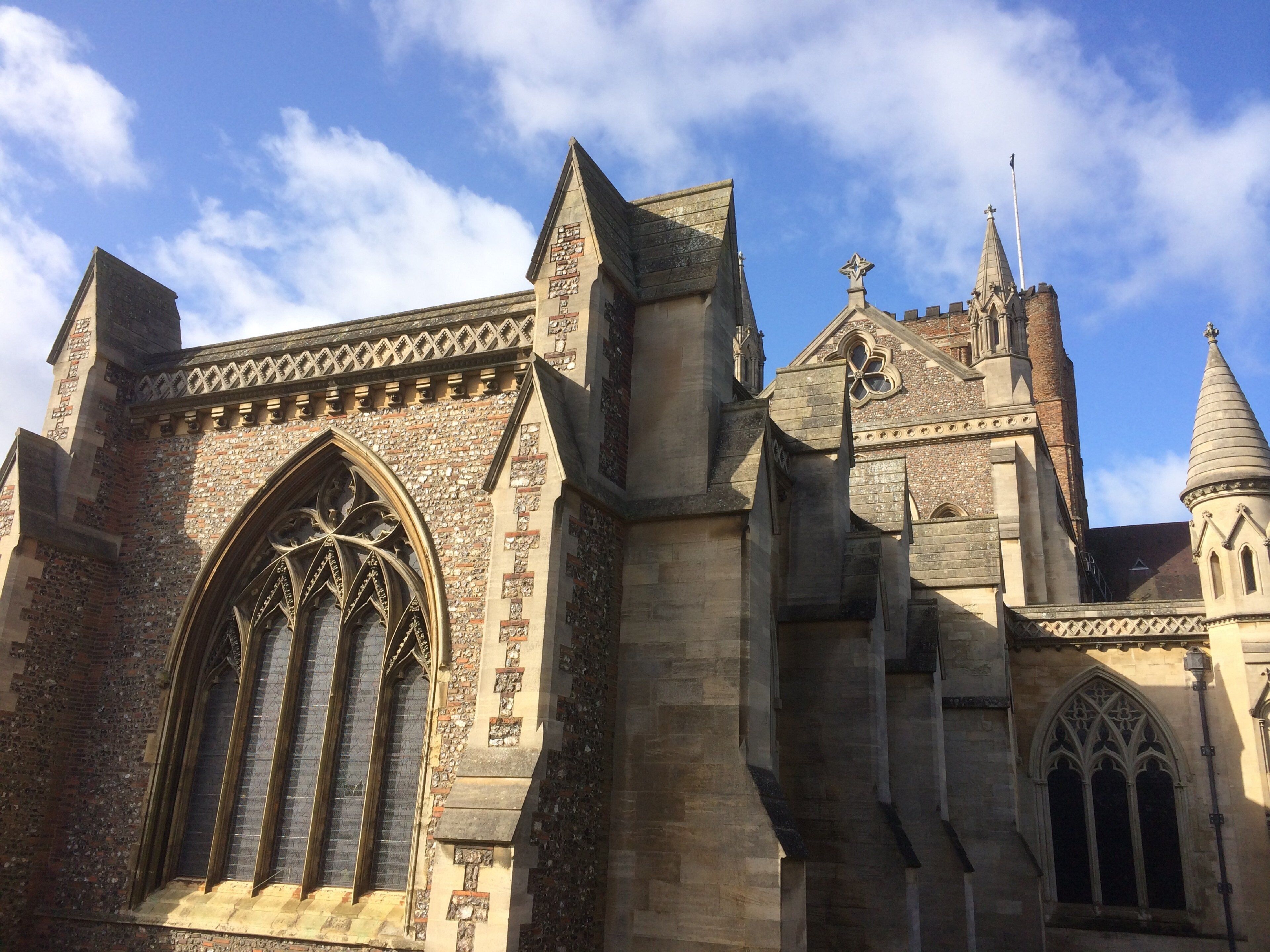 A historic building with a large arched window and pointed roofline.