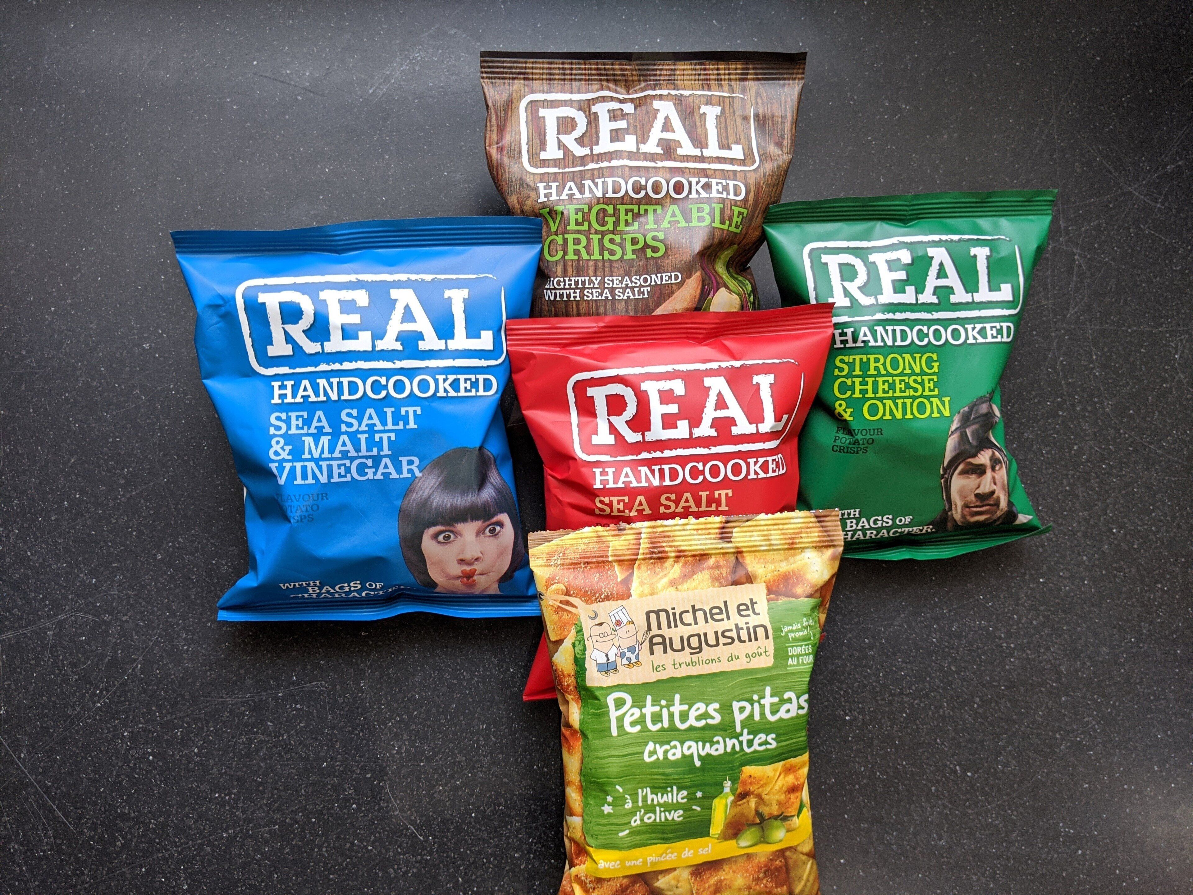 Various snack bags including sea salt and malt vinegar chips, potato crisps, and French fries.