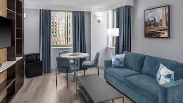 Suite, 1 King Bed | Living area | 42-inch LCD TV with cable channels, TV, iPod dock