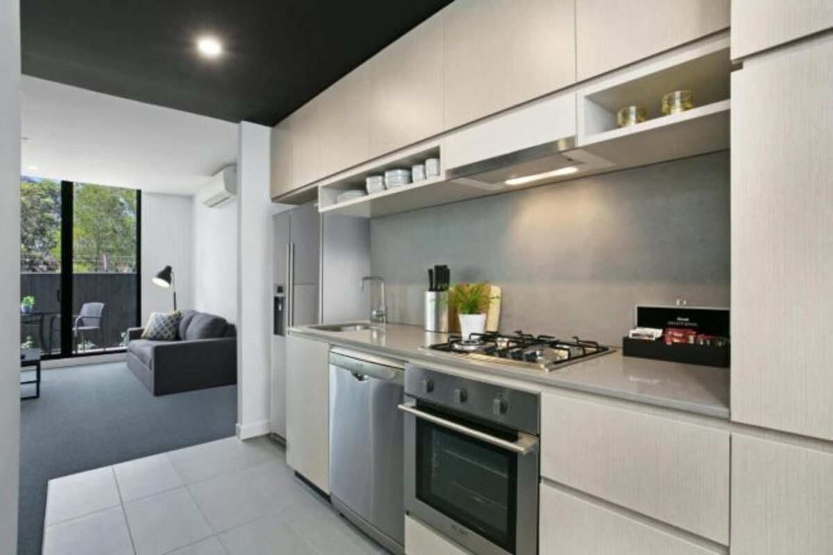 A modern kitchen with built-in appliances, a dishwasher, and a gas stove.