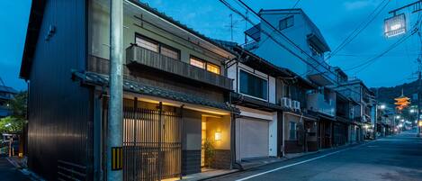 A row of traditional Japanese buildings with a street in front.