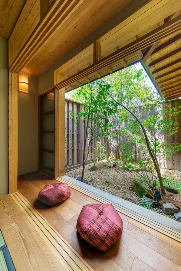A wooden interior with a view of a garden.