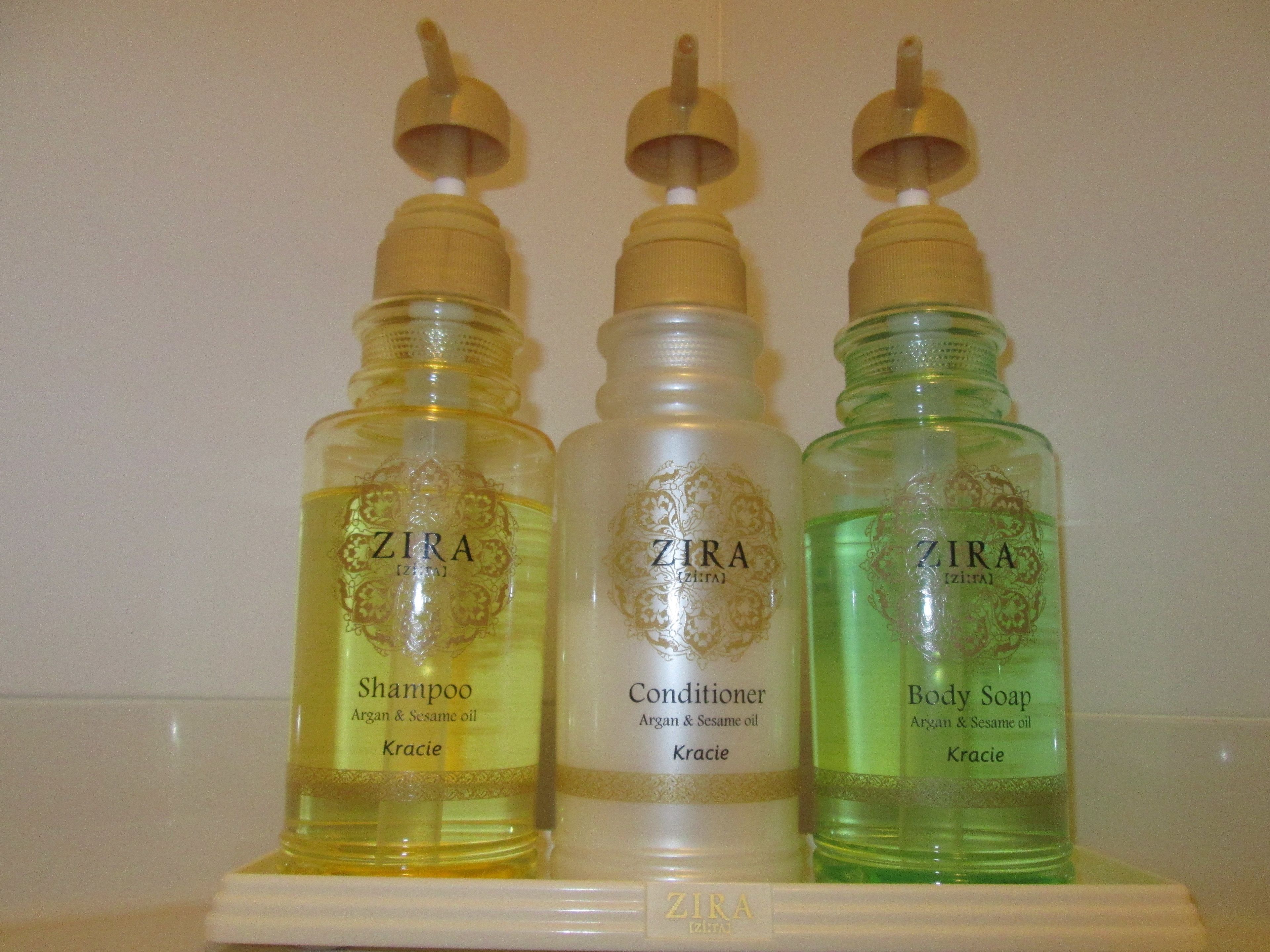 Three bottles of ZIRA skincare products on a shelf.