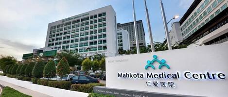 A medical center with a sign reading "Mahkota Medical Centre" and "Ibu Hati Klinik".