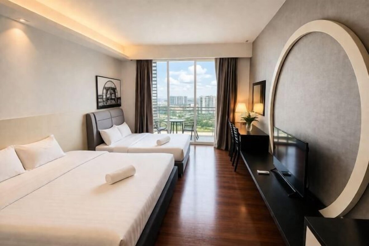 A hotel room with two beds, a TV, a desk, and a large window with a city view.