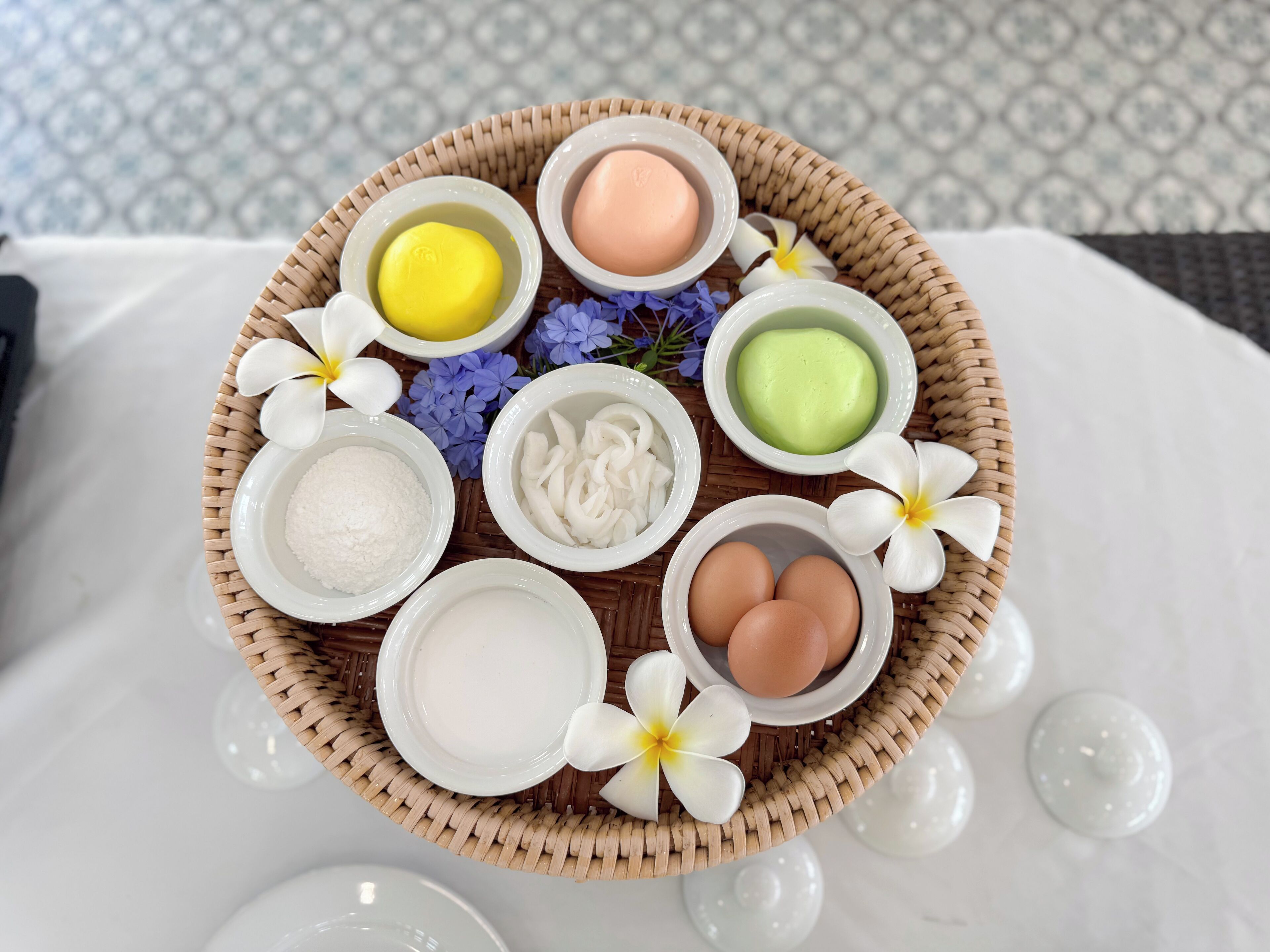 A basket containing various bath products including soaps, oils, and eggs.