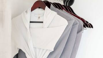 A rack of robes hanging on a wall.