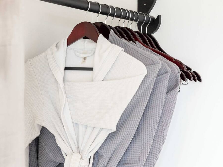 A rack of robes hanging on a wall.