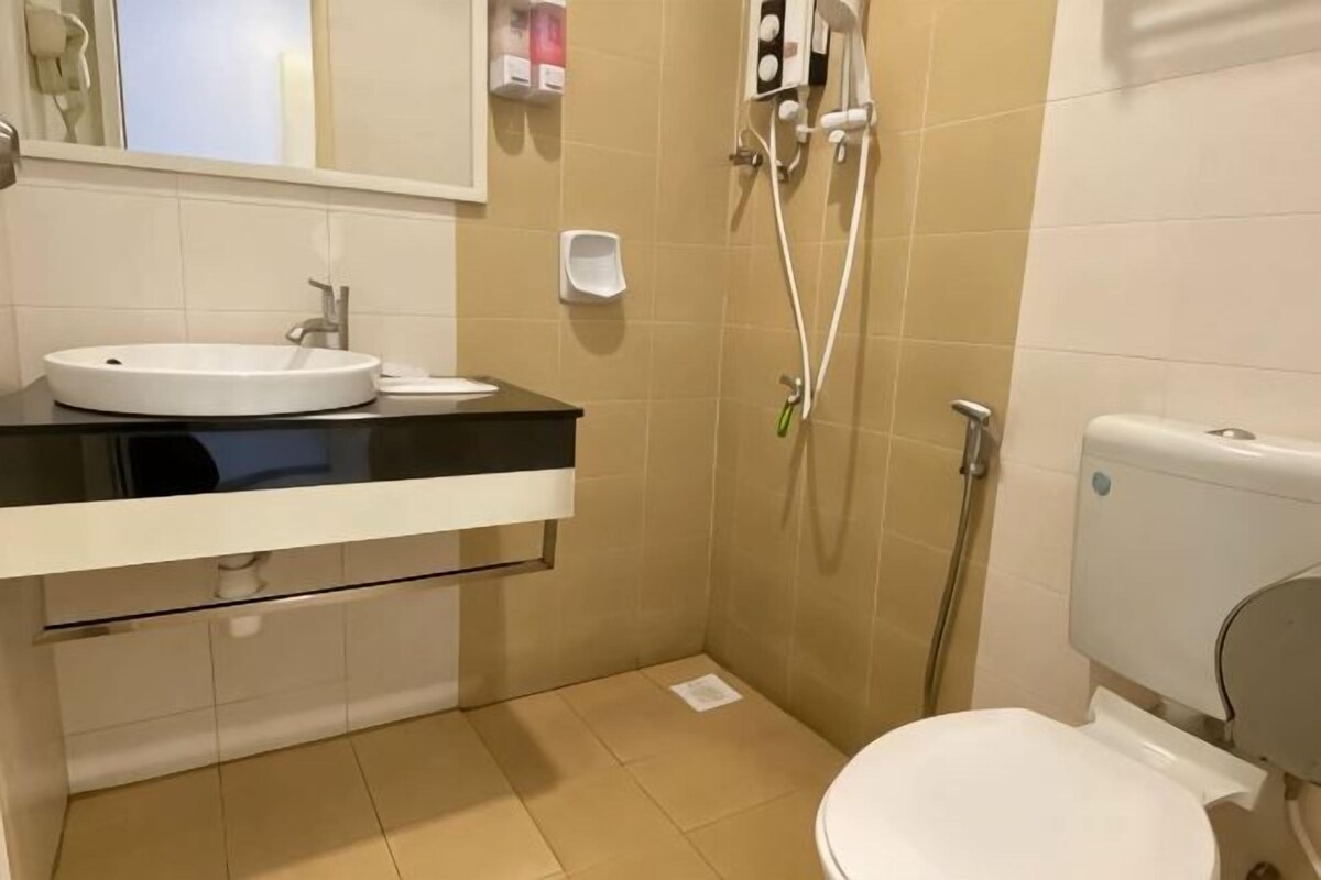A bathroom with a sink, toilet, and shower.
