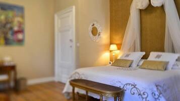 A bedroom with a bed, bedside table, and a lamp.